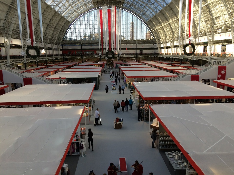 Overhead View of People Exploring a Food Trade Show with Several Expo Booths with Roofs